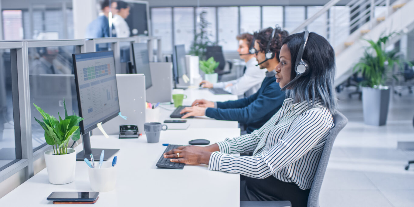 Team of Customer Service Operators Working at a Call Center Team of Customer Service Operators Working at a Call Center