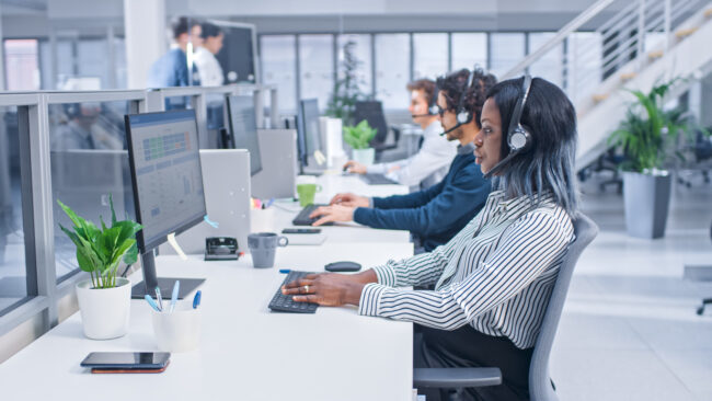 Team of Customer Service Operators Working at a Call Center