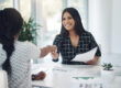 Shot of two young businesswomen shaking hands in a modern office