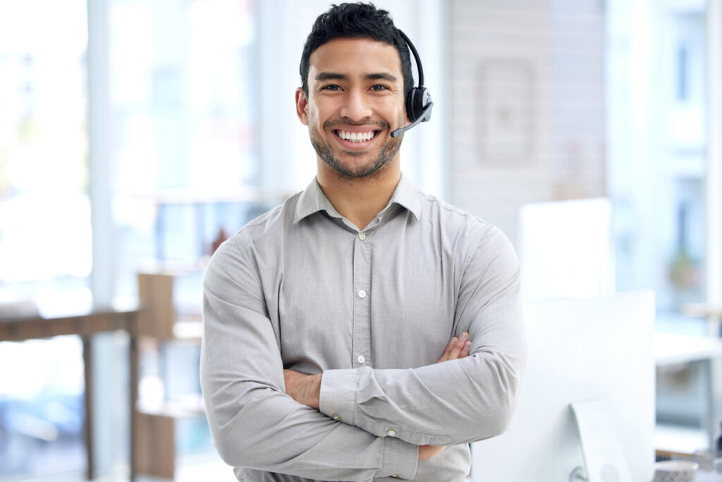 Portrait of a young businessman using a headset in a modern office